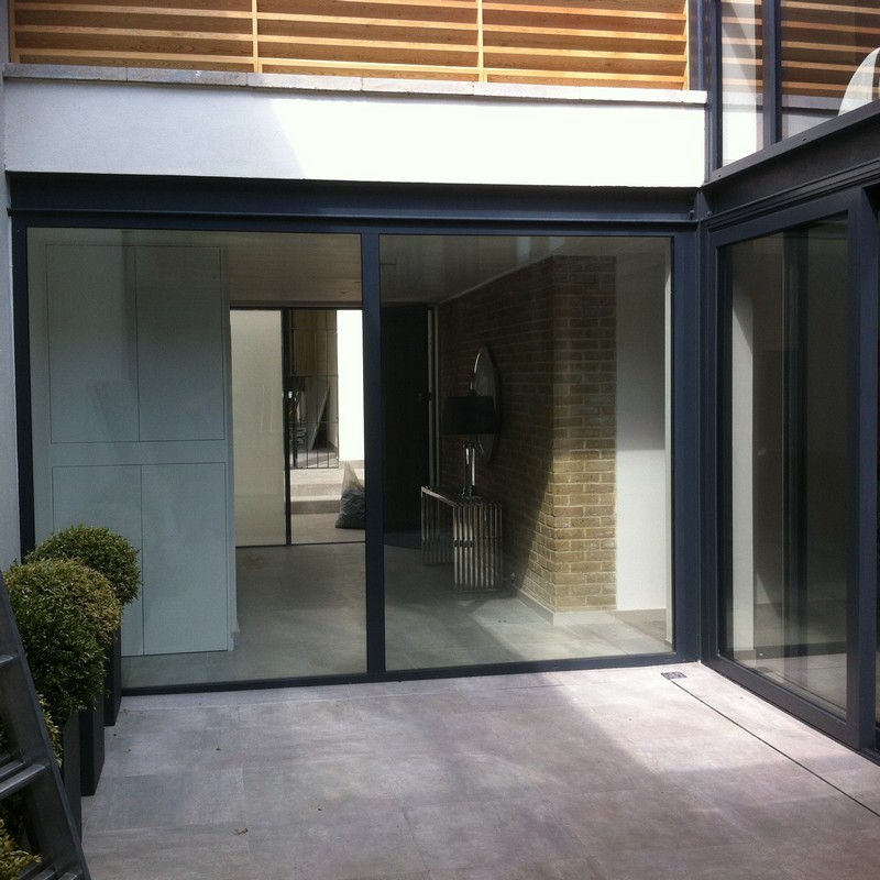 Floor-to-ceiling sliding doors opening to courtyard in Kensal Green