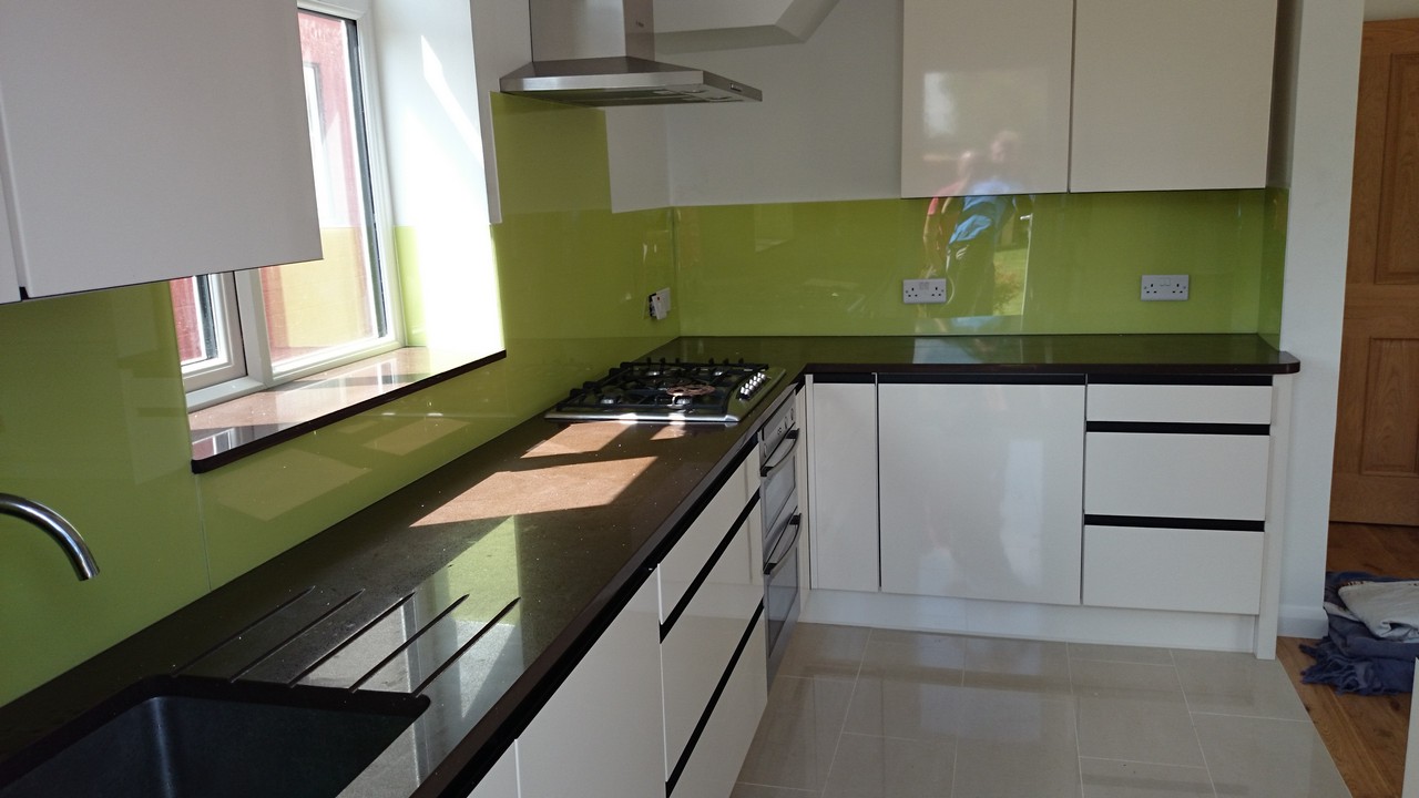 Lime green glass kitchen splashback installed by Kensal Green glaziers