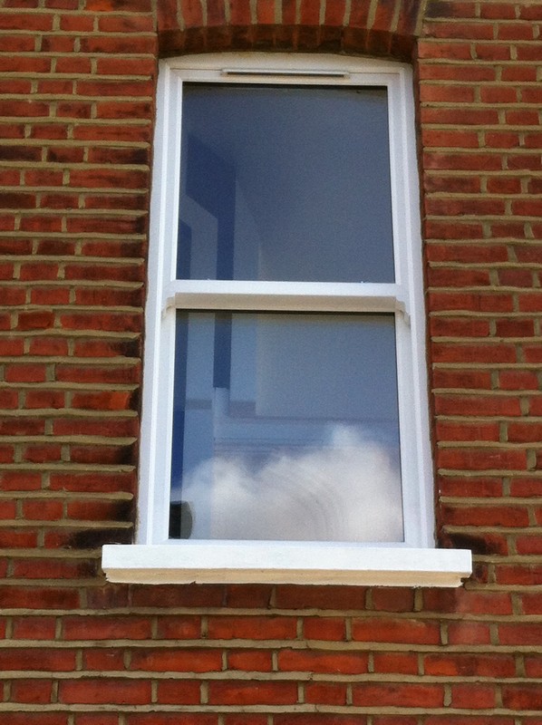 uPVC sash window on Victorian red brick house in Kensal Green